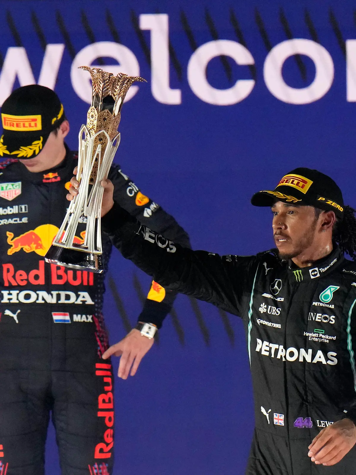 Mercedes driver Lewis Hamilton of Britain celebrates winning the Formula One Saudi Arabian Grand Prix in front of the second placed Red Bull driver Max Verstappen of the Netherlands, in Jiddah, Sunday, Dec. 5, 2021. (AP Photo/Hassan Ammar)