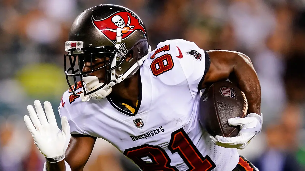 FILE - Tampa Bay Buccaneers wide receiver Antonio Brown runs with the ball during an NFL football game against the Philadelphia Eagles, Oct. 14, 2021, in Philadelphia. Brown and two other NFL players have been suspended immediately for three games by the league for violating COVID-19 protocols. Brown and teammate Mike Edwards were suspended Thursday, Dec. 2, 2021. Free agent John Franklin III, if signed by a team, is also ineligible to play in the next three games. (AP Photo/Matt Rourke, File)