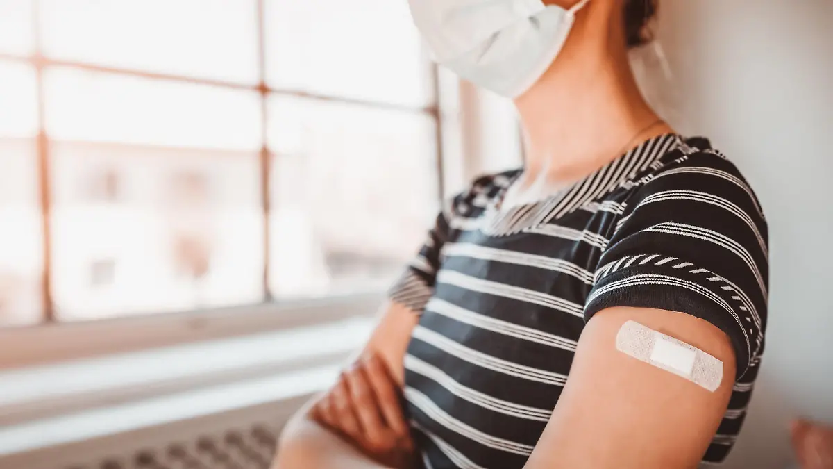 Woman in the hospital after inoculation against Covid 19. Concept immunization and making injections from pandemic of SARS.