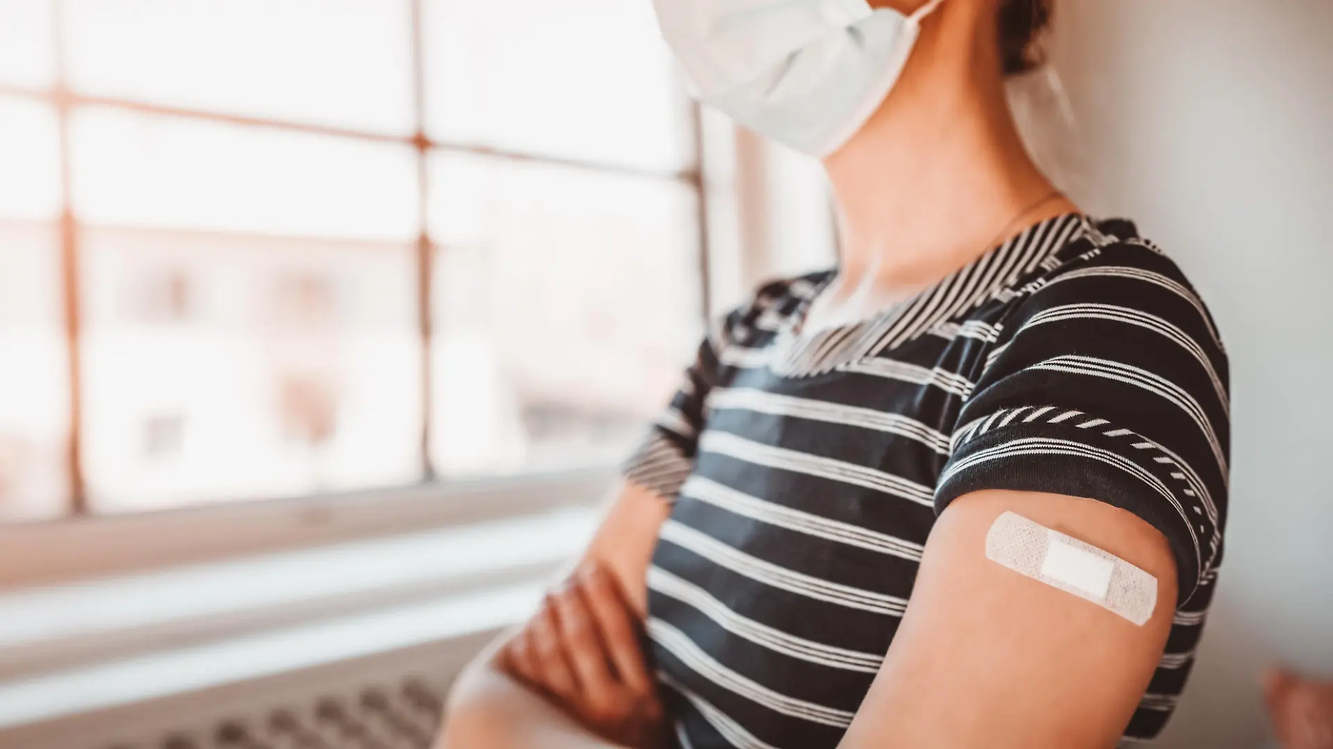 Woman in the hospital after inoculation against Covid 19. Concept immunization and making injections from pandemic of SARS.