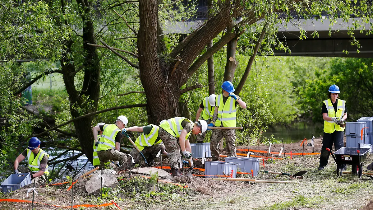 Royal Army military police officers dig for remains of Katrice Lee, a two-year-old girl who went missing 36 years ago in Germany where her father was stationed with the British army at the time, near the river of Alme in Paderborn, Germany, May 3, 2018.  REUTERS/Wolfgang Rattay