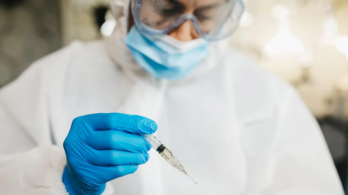 Doctor in protective suit work on vaccine against covid19 virus