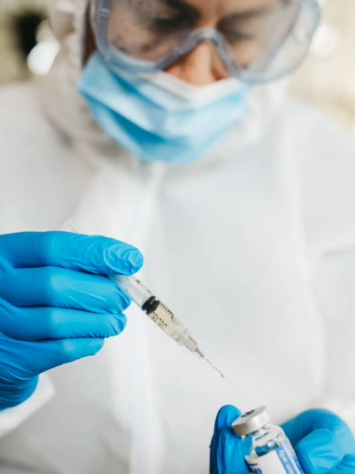Doctor in protective suit work on vaccine against covid19 virus