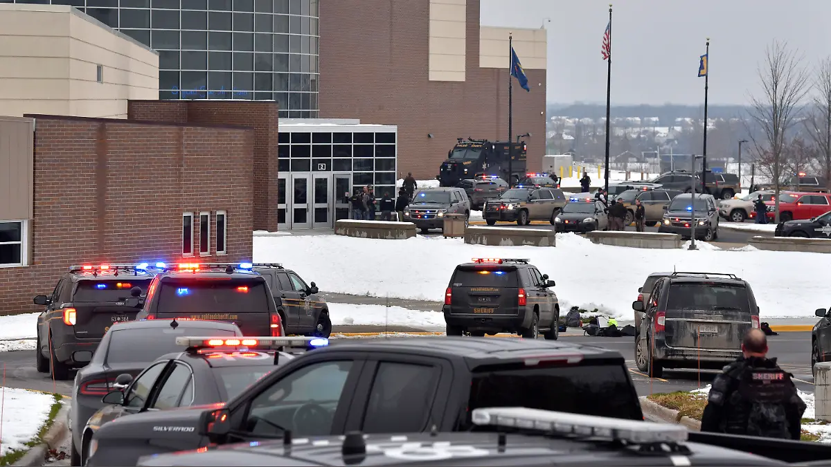 Dozens of police, fire, and EMS personnel work on the scene of a shooting at Oxford High School, Tuesday, Nov. 30, 2021, In Oxford Township, Mich. (Todd McInturf/The Detroit News via AP)