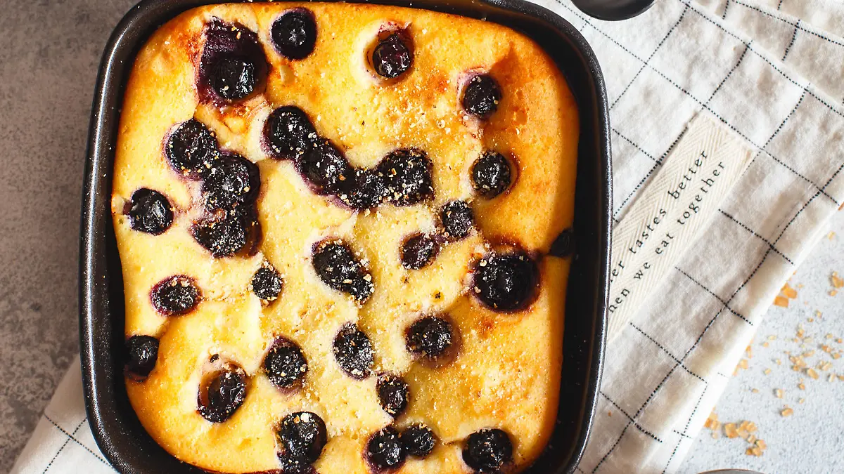 Cottage cheese casserole baked with blueberry. Curd casserole with fresh berries on kitchen table. Top view