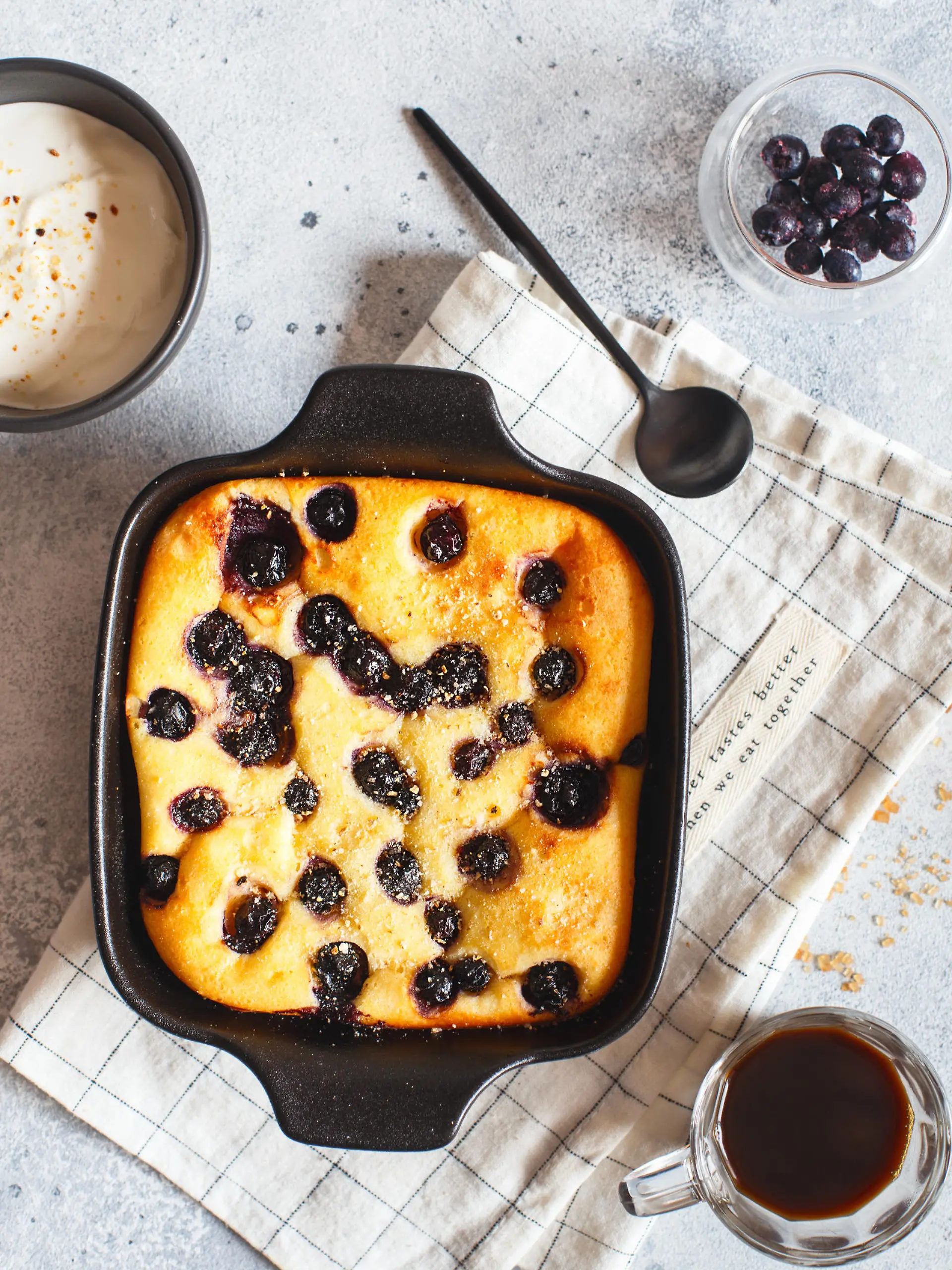 Cottage cheese casserole baked with blueberry. Curd casserole with fresh berries on kitchen table. Top view