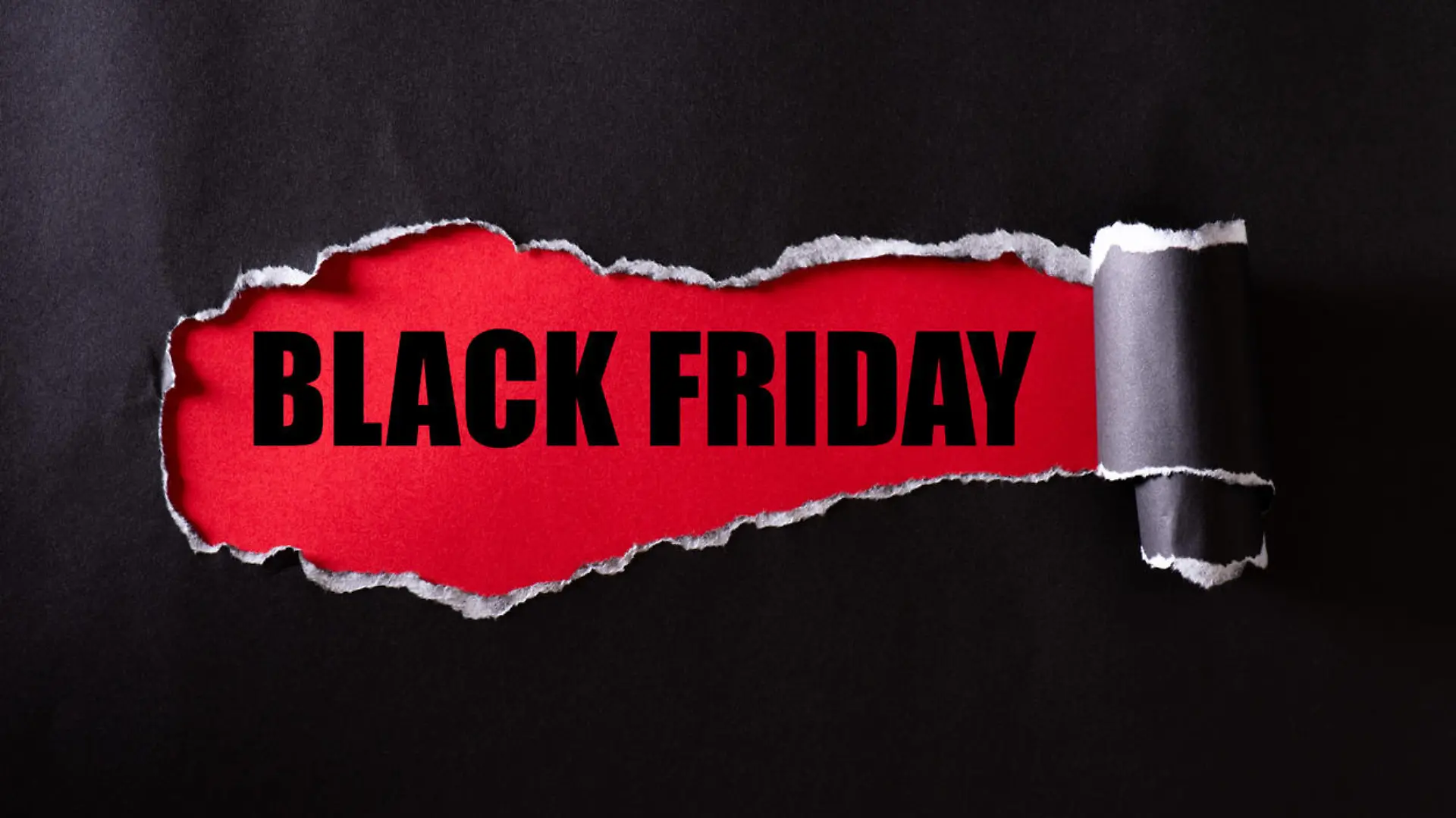 Top view of Black torn paper and the text black friday on a red background. Black Friday composition.