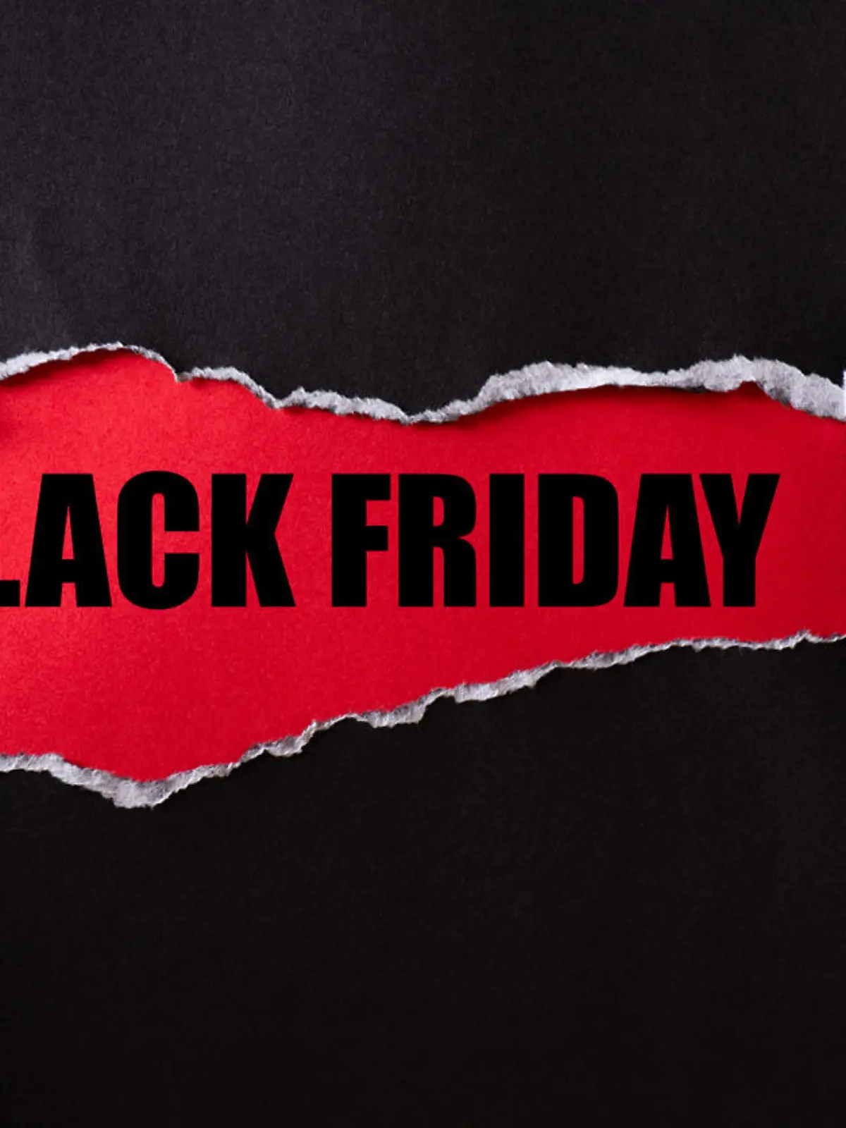 Top view of Black torn paper and the text black friday on a red background. Black Friday composition.