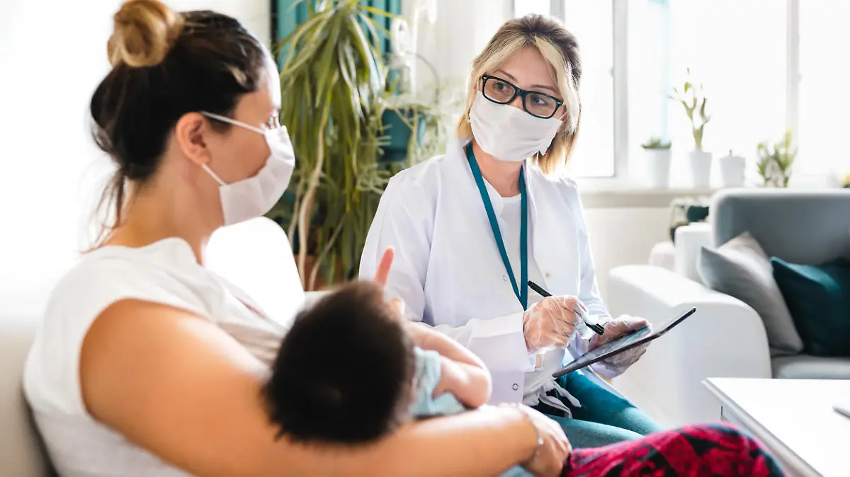 Female Pediatrician visiting newborn baby at home during Lockdown