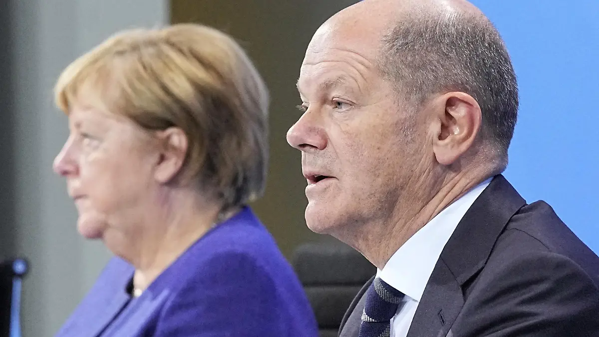 German Chancellor Angela Merkel and Germany's Social Democratic Party (SPD) candidate for chancellor Olaf Scholz attend a news conference in the Federal Chancellery following the video conference with the country's 16 state leaders on the surge in the coronavirus disease (COVID-19) cases, in Berlin, Germany, November 18, 2021. Michael Kappeler/Pool via REUTERS