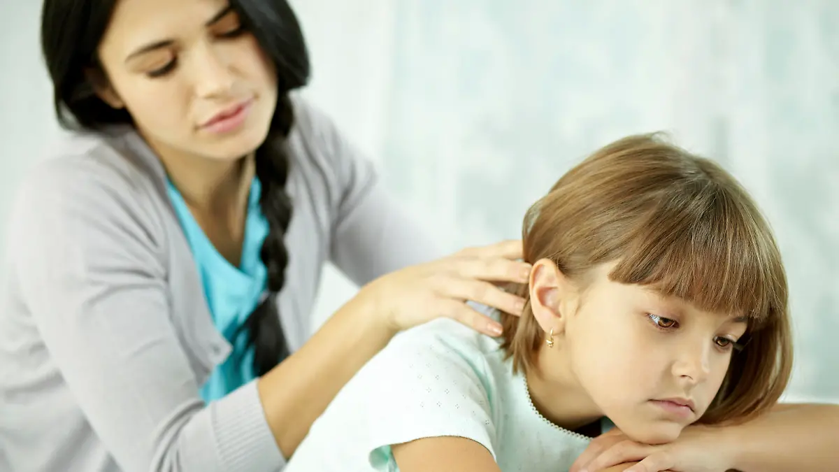 Woman consoling her upset child
