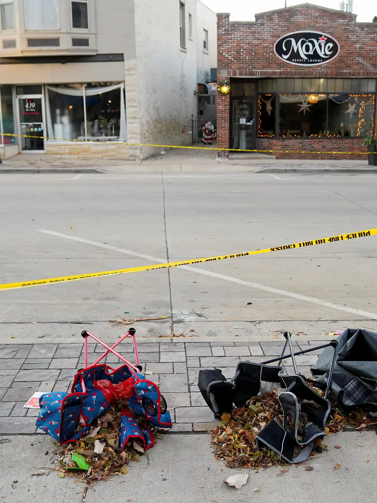 Chairs are left abandonded on Main Street the morning after a car plowed through a holiday parade in Waukesha, Wisconsin, U.S., November 22, 2021.  REUTERS/Cheney Orr