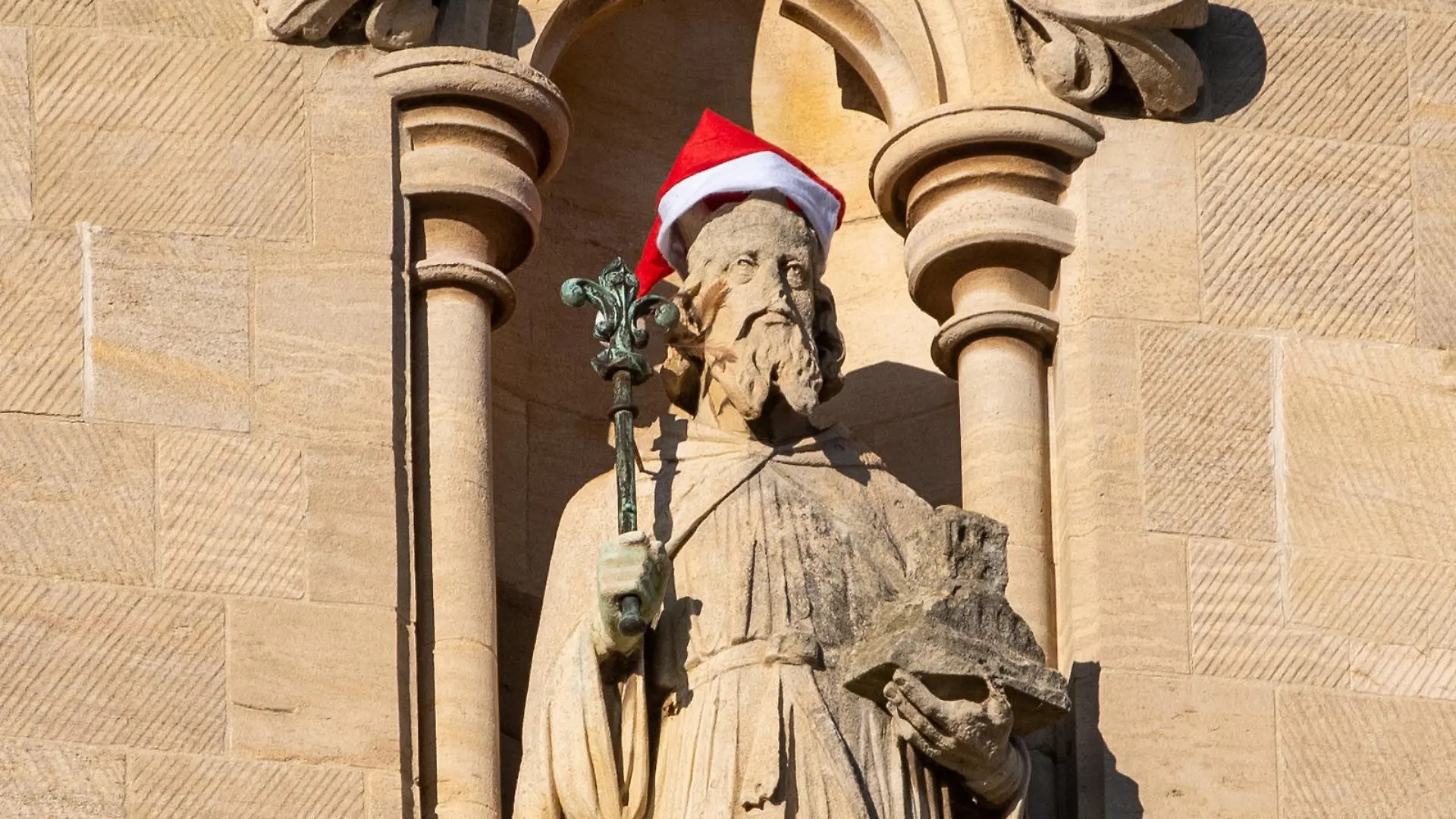 Santa Hats have been placed on Statues and a gargoyle on St Johns College Chapel in Cambridge
