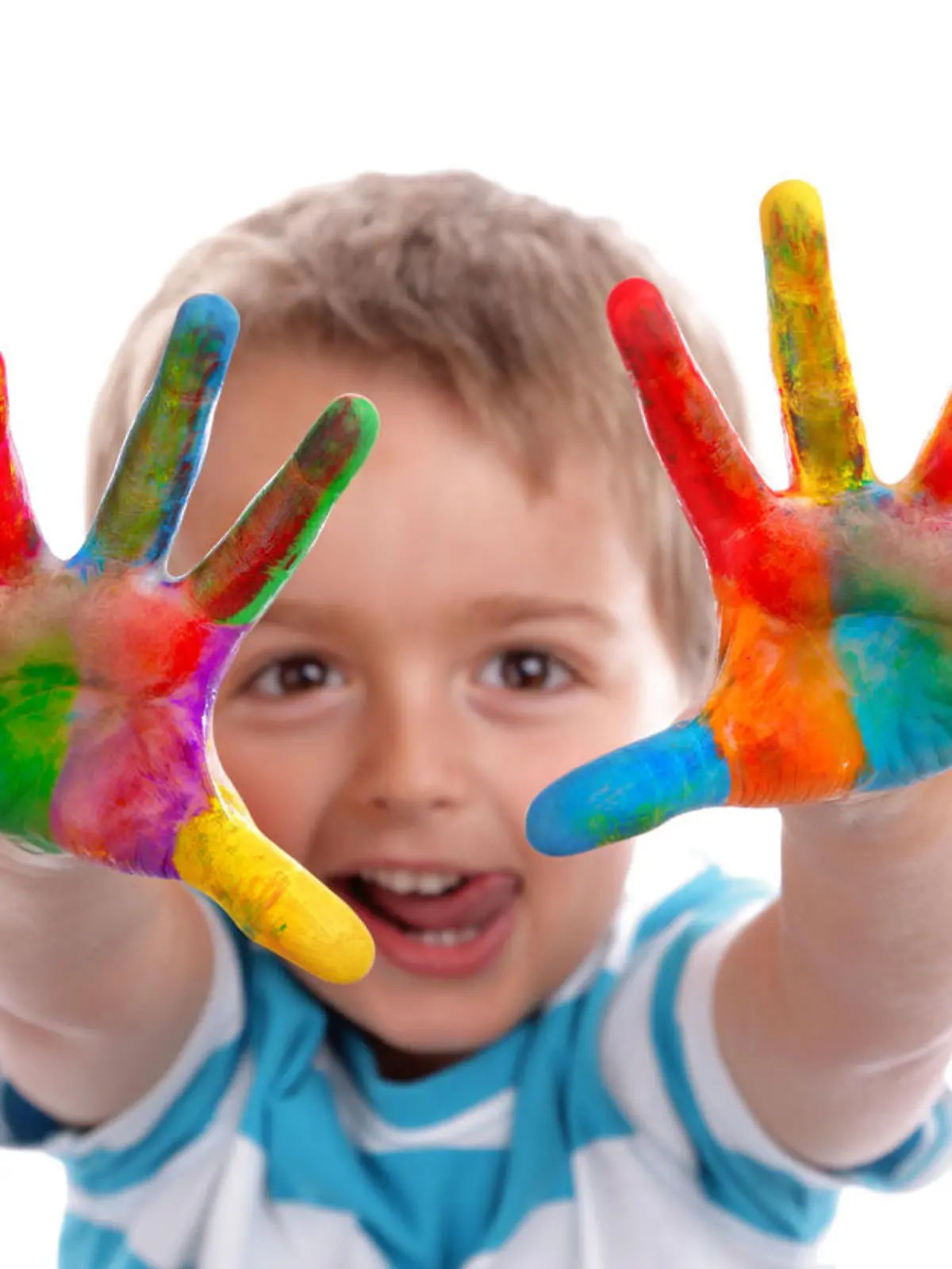 Boy with hands painted in colorful paints ready to make hand prints