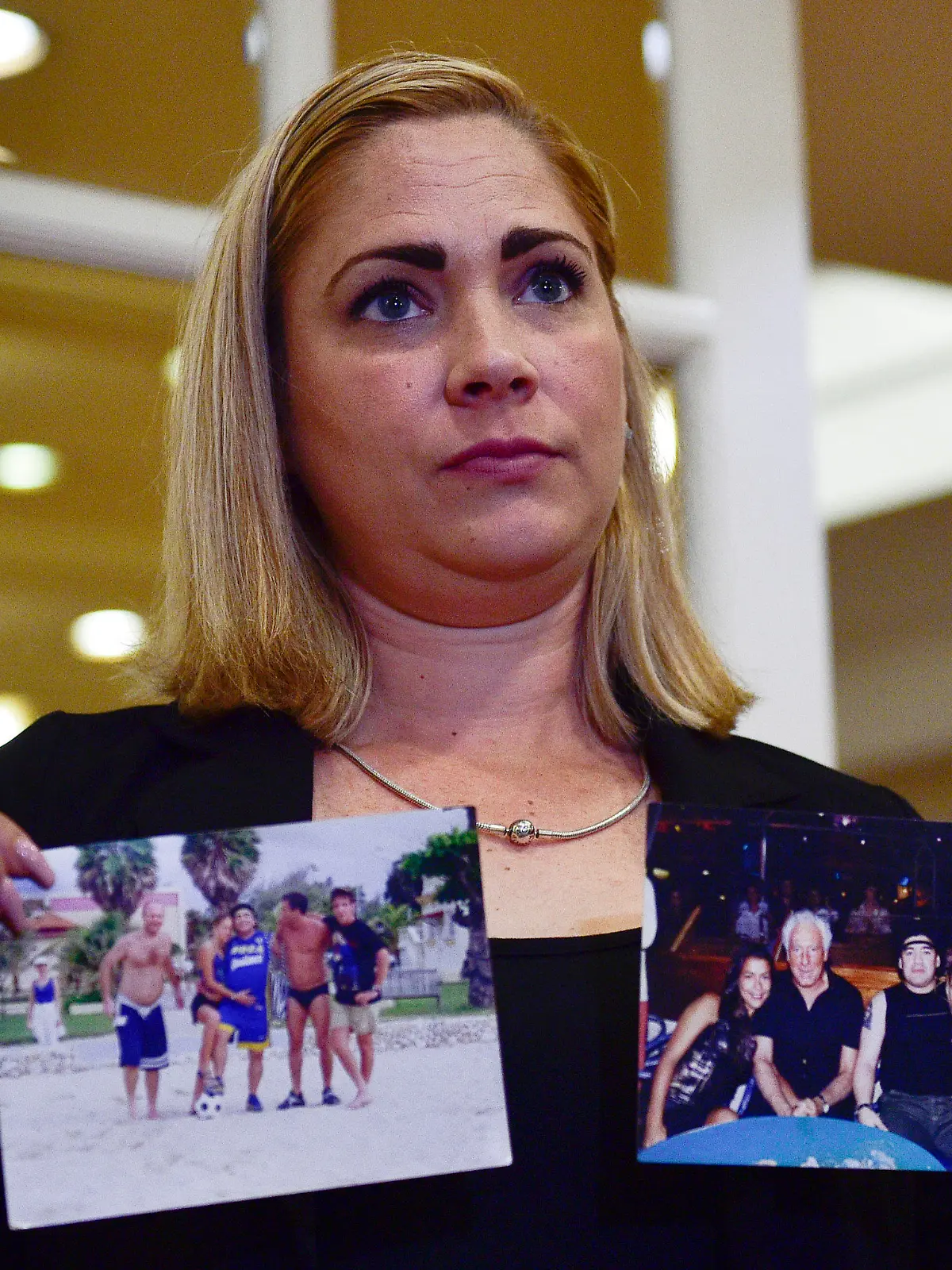 Mavys Alvarez shows photographs of her with Diego Maradona in Havana, Cuba, at the end a press conference in Buenos Aires, Argentina, Monday, Nov. 22, 2021. Alvarez, who as a teenager had a sentimental relationship with Diego Maradona in Cuba during which she says she suffered abuse, testified last week as a witness before the court in Buenos Aires in the framework of a complaint against relatives of Maradona for alleged human trafficking. (AP Photo/Gustavo Garello)