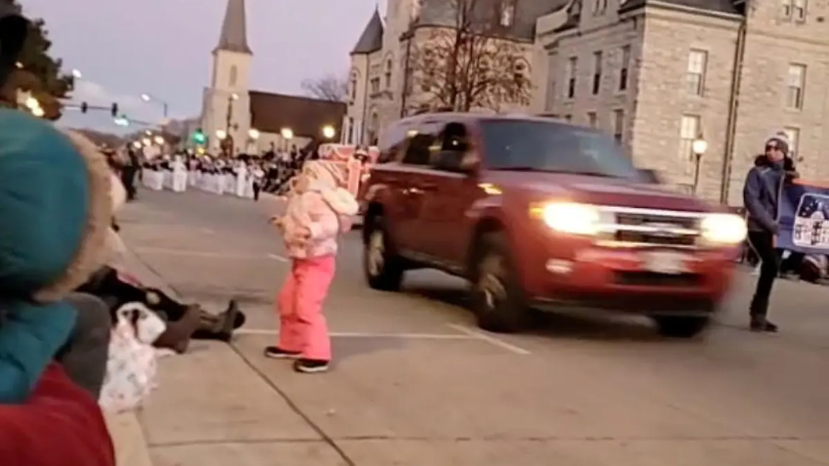 An SUV speeds past moments before plowing into a crowd of people during a Christmas parade in Waukesha, Wisconsin, U.S., in this still image taken from a November 21, 2021 social media video. JESUS OCHOA/via REUTERS THIS IMAGE HAS BEEN SUPPLIED BY A THIRD PARTY. MANDATORY CREDIT. NO RESALES. NO ARCHIVES.