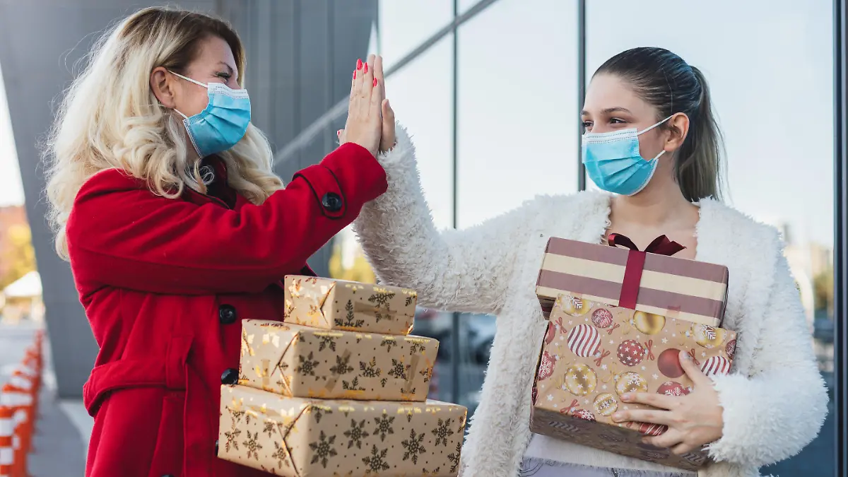Family shopping Christmas gifts during COVID-19 pandemic. They wears a protective mask to protect from corona virus COVID-19.