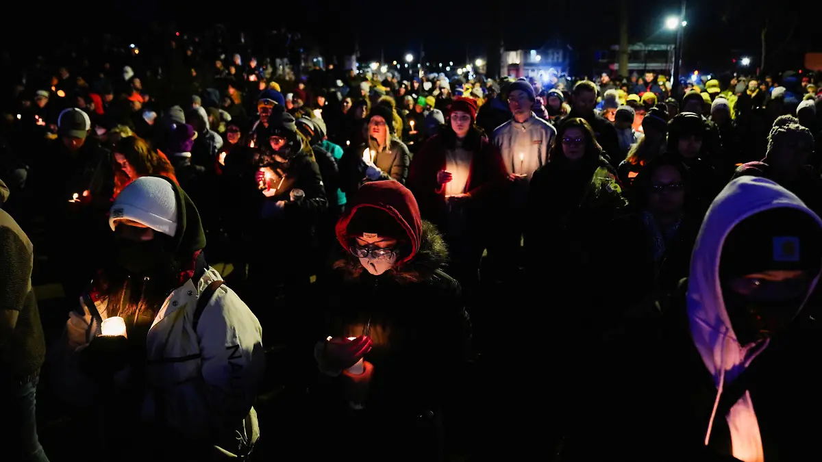 Community members mourn during a candle light vigil in Cutler Park after a car plowed through a holiday parade in Waukesha, Wisconsin, U.S., November 22, 2021.  REUTERS/Cheney Orr