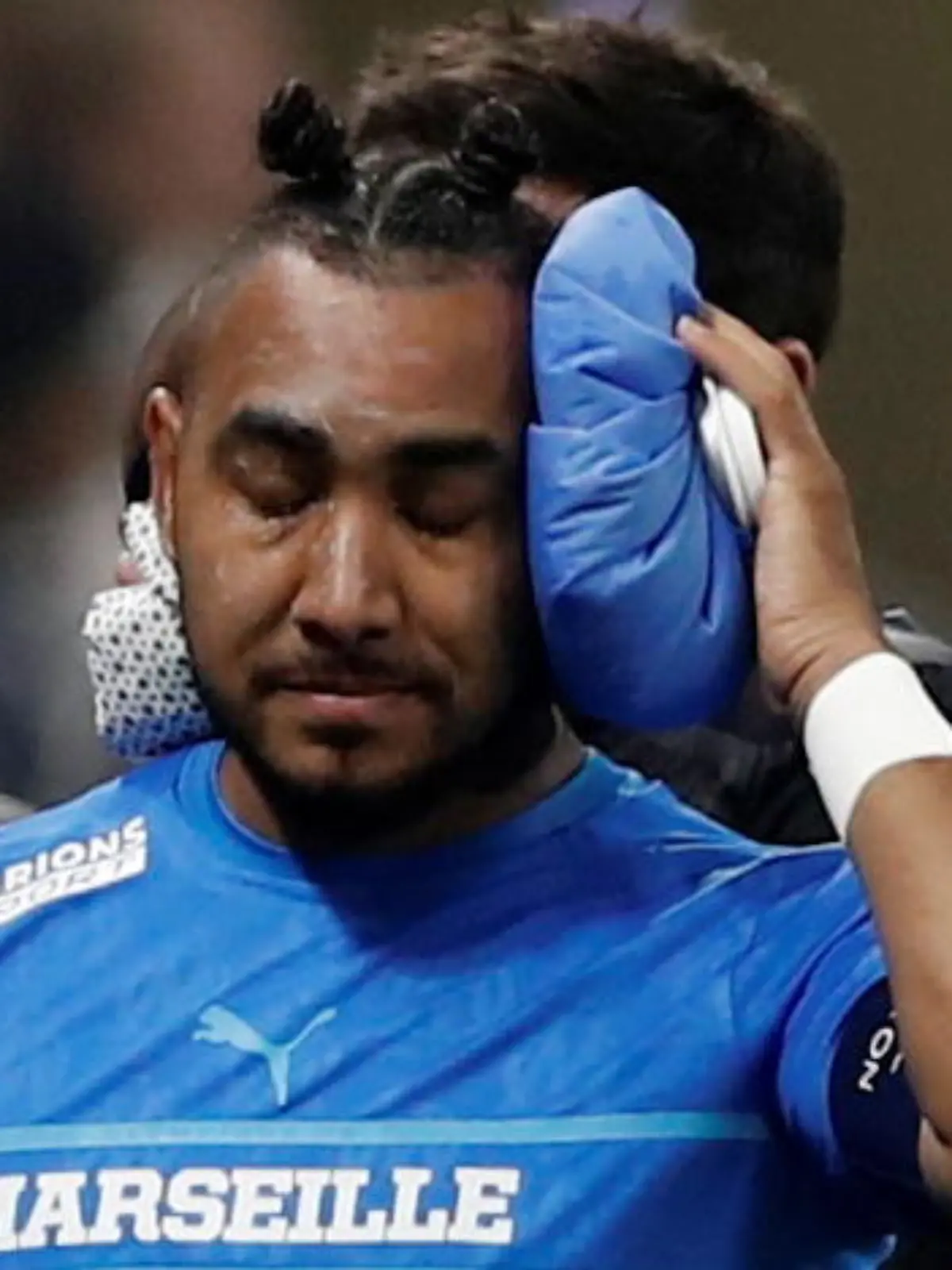 Soccer Football - Ligue 1 - Olympique Lyonnais v Olympique de Marseille - Groupama Stadium, Lyon, France - November 21, 2021  Olympique de Marseille's Dimitri Payet walks off the pitch injured after being hit by a water bottle thrown by a fan leading to the game being interrupted REUTERS/Benoit Tessier