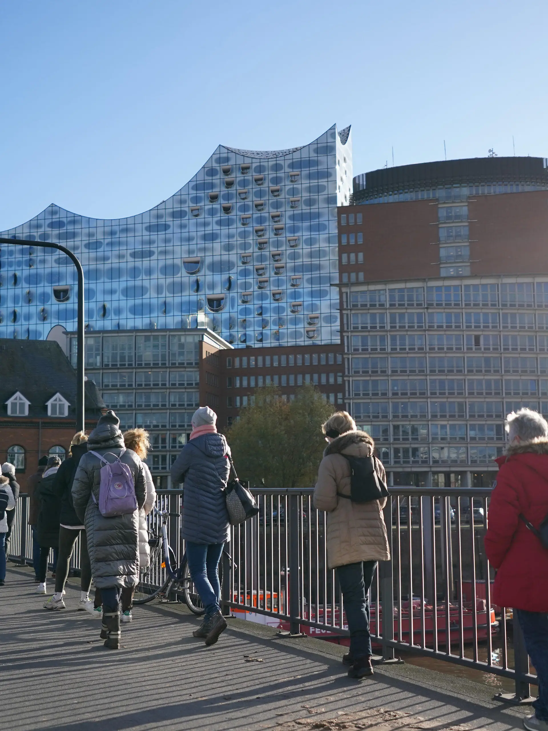 22.11.2021, Hamburg: Unzählige Menschen stehen in einer mehreren hundert Meter langen Schlange zur Impfaktion in der Elbphilharmonie an. Von der Elbphilharmonie bis fast zu den Landungsbrücken stehen die Menschen für die Impfung an. Neben Drittimpfungen werden auch Erst- und Zweitimpfungen angeboten. Verwendet werden bei der Aktion in Zusammenarbeit mit der Hamburger Sozialbehörde die Impfstoffe von Biontech, Moderna und Johnson & Johnson. Foto: Marcus Brandt/dpa +++ dpa-Bildfunk +++