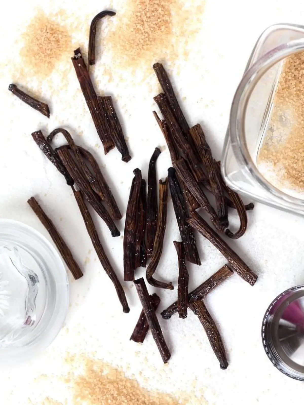Homemade vanilla white and brown sugar in a glass jar with vanilla sticks