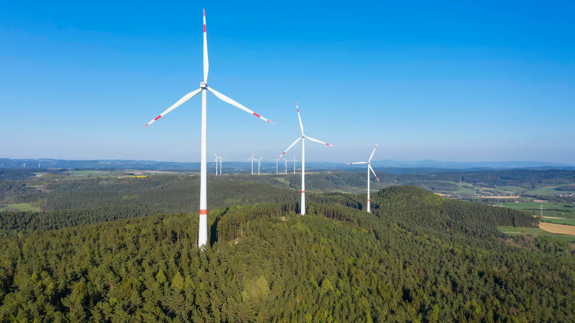 Drone view of forest wind farm in spring RUEF03351