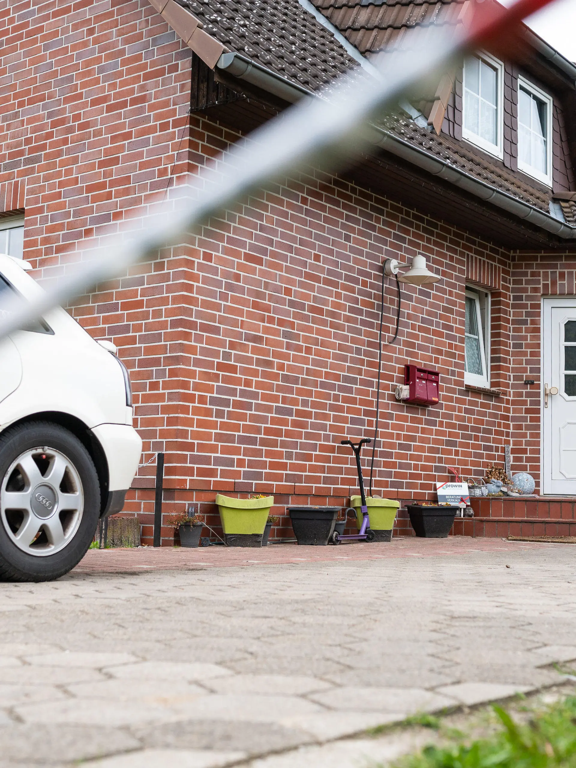 ARCHIV - 18.05.2021, Niedersachsen, Bispingen: Absperrband der Polizei hängt vor einem Wohnhaus. Eine Frau und ihr vierjähriger Sohn wurden am 16.05.2021 tot in dem Haus entdeckt, die Leiche ihrer elfjährigen Tochter später in einem Waldstück gefunden. (Zu dpa: «Mordprozess gegen 35-Jährigen nach Tod von Mutter und Kindern») Foto: Philipp Schulze/dpa +++ dpa-Bildfunk +++