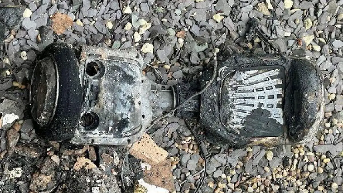 Shocking footage of the moment a hoverboard battery exploded leaving a mum fighting for her life has been released.

A ferocious blaze broke out at a family home in Stony Lane, Smethwick, Birmingham, after the device set alight while charging - just feet away from bed-bound Jacqueline Barrett.

Pic shows remnants of hoverboard
Credit: BPM Media