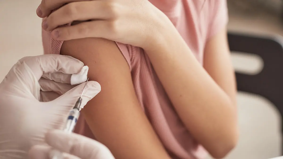 Close up of unrecognizable doctor vaccinating child in medical clinic, copy space