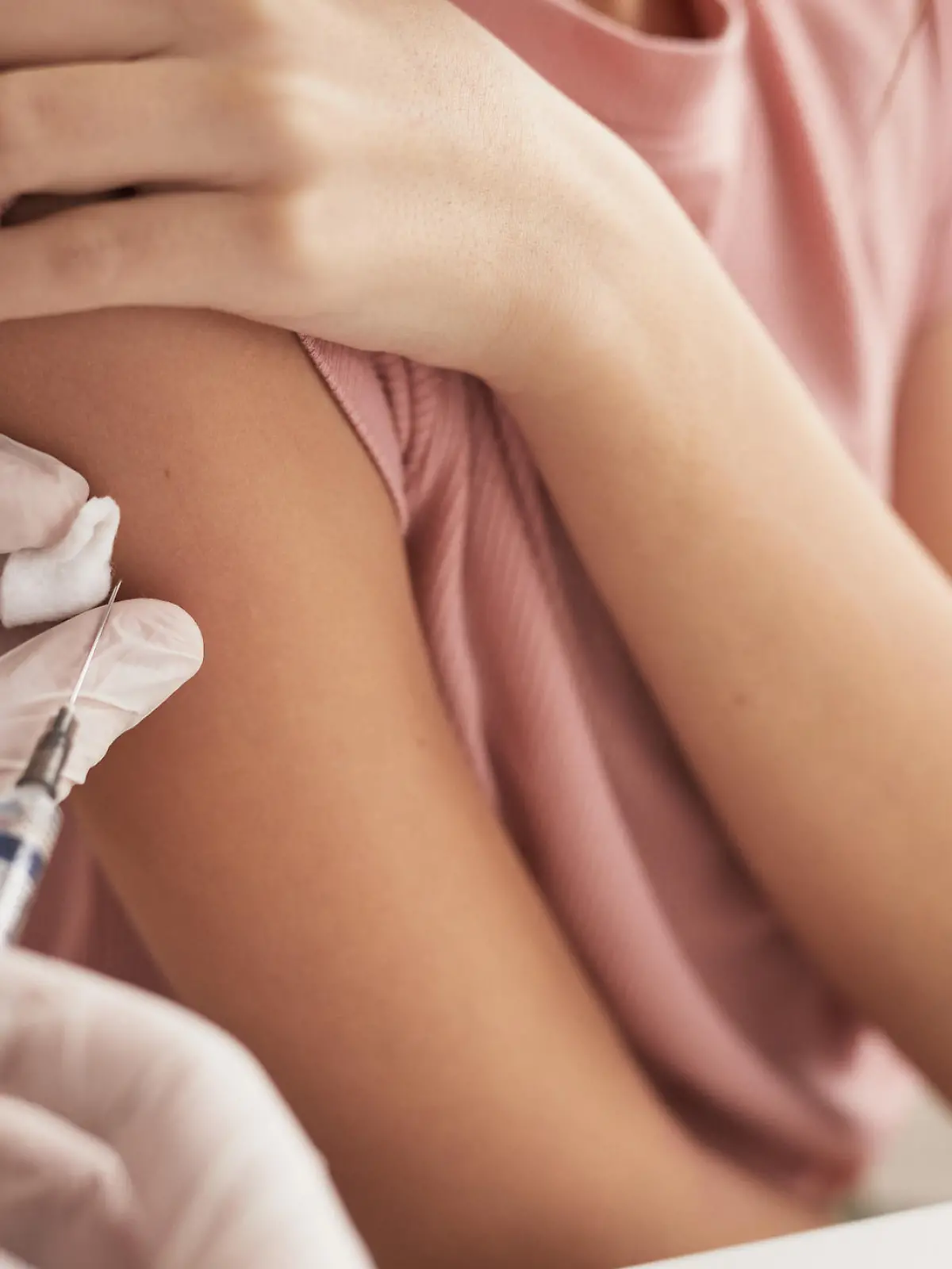 Close up of unrecognizable doctor vaccinating child in medical clinic, copy space