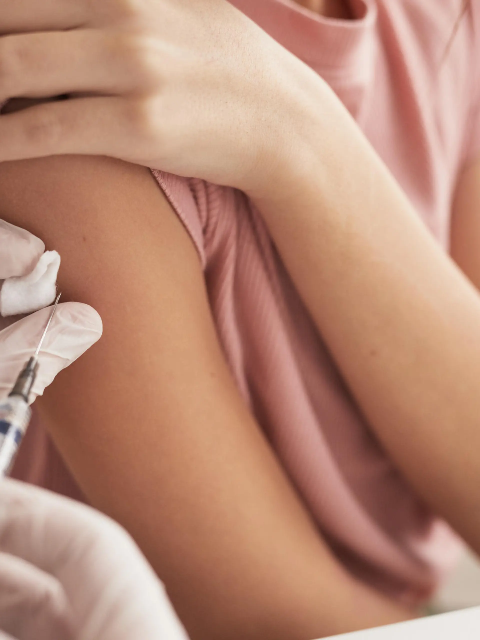 Close up of unrecognizable doctor vaccinating child in medical clinic, copy space