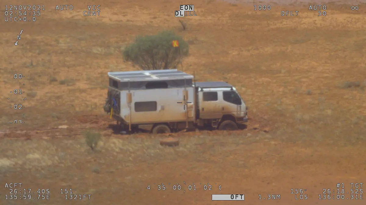 A campervan is seen stranded in a flooded area in the Simpson Desert, Australia November 12, 2021. Picture taken November 12, 2021. Australian Maritime Safety Authority (AMSA) via REUTERS THIS IMAGE HAS BEEN SUPPLIED BY A THIRD PARTY. NO RESALES. NO ARCHIVES. MANDATORY CREDIT.