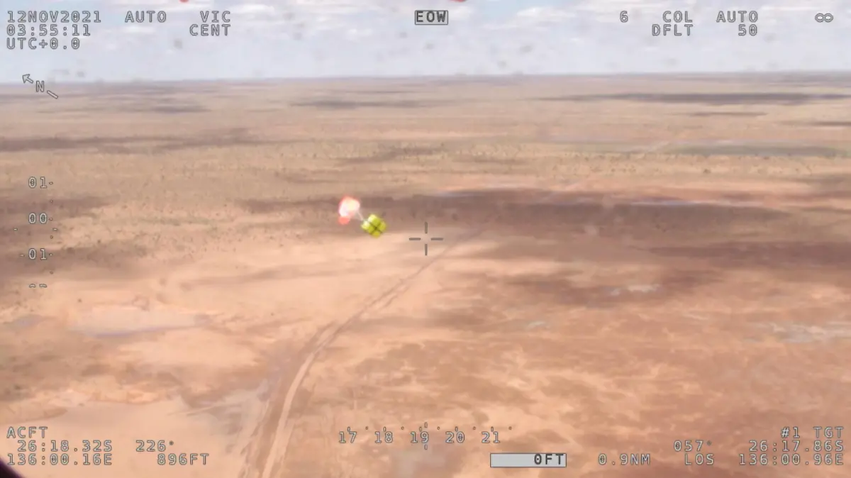 Supplies are being airdropped by authorities after torrential rain bogged a campervan, at a flooded area in the Simpson Desert, Australia November 12, 2021 in this screen grab taken from an aerial footage. Video taken November 12, 2021. Australian Maritime Safety Authority (AMSA) via REUTERS THIS IMAGE HAS BEEN SUPPLIED BY A THIRD PARTY. NO RESALES. NO ARCHIVES. MANDATORY CREDIT.