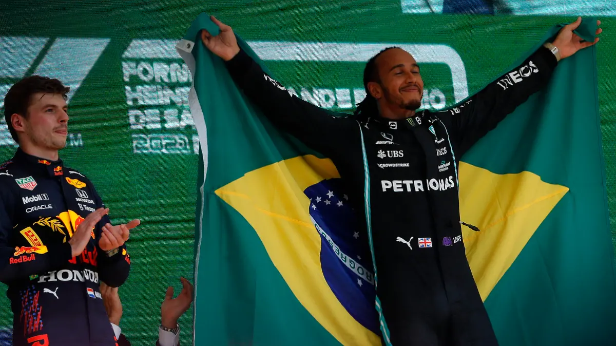 Mercedes driver Lewis Hamilton, of Britain, right, celebrates his victory over Red Bull driver Max Verstappen, of The Netherlands, right, in the Brazilian Formula One Grand Prix at the Interlagos race track in Sao Paulo, Brazil, Sunday, Nov. 14, 2021. Max Verstappen finished second. (AP Photo/Marcelo Chello)