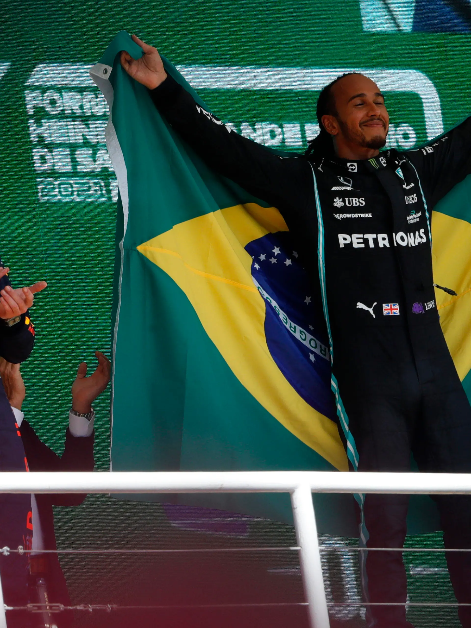 Mercedes driver Lewis Hamilton, of Britain, right, celebrates his victory over Red Bull driver Max Verstappen, of The Netherlands, right, in the Brazilian Formula One Grand Prix at the Interlagos race track in Sao Paulo, Brazil, Sunday, Nov. 14, 2021. Max Verstappen finished second. (AP Photo/Marcelo Chello)