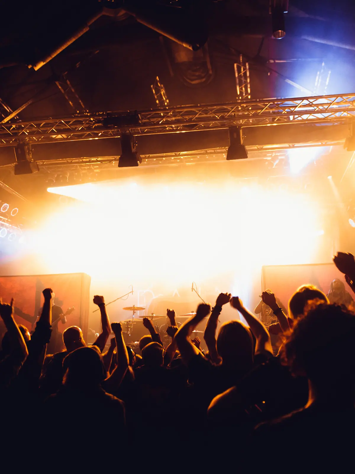 Colorful crowd of uncrecognized people of a big music festival or concert in a stage lights as a beautiful background