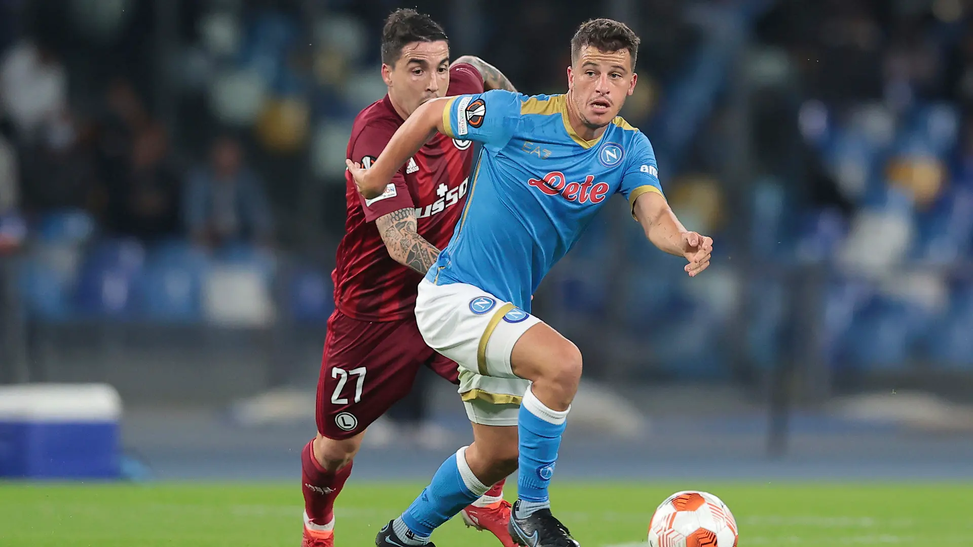 Napoli's Diego Demme, right, and Legia's Josue fight for the ball during a group C Europa League soccer match between Napoli and Legia, at Naples’ Diego Armando Maradona Stadium, Italy, Thursday, Oct. 21, 2021. (Alessandro Garofalo/LaPresse via AP)
