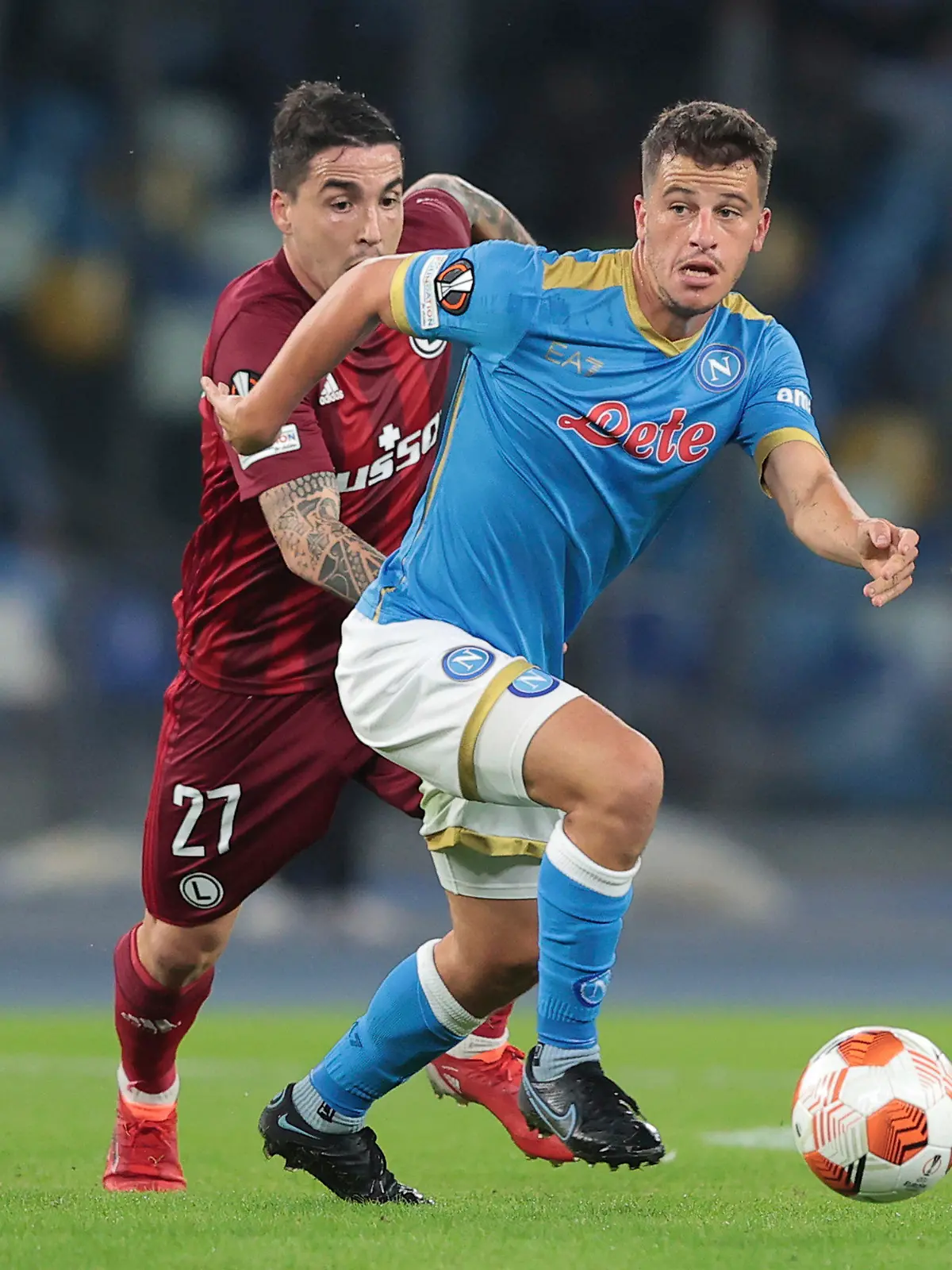 Napoli's Diego Demme, right, and Legia's Josue fight for the ball during a group C Europa League soccer match between Napoli and Legia, at Naples’ Diego Armando Maradona Stadium, Italy, Thursday, Oct. 21, 2021. (Alessandro Garofalo/LaPresse via AP)