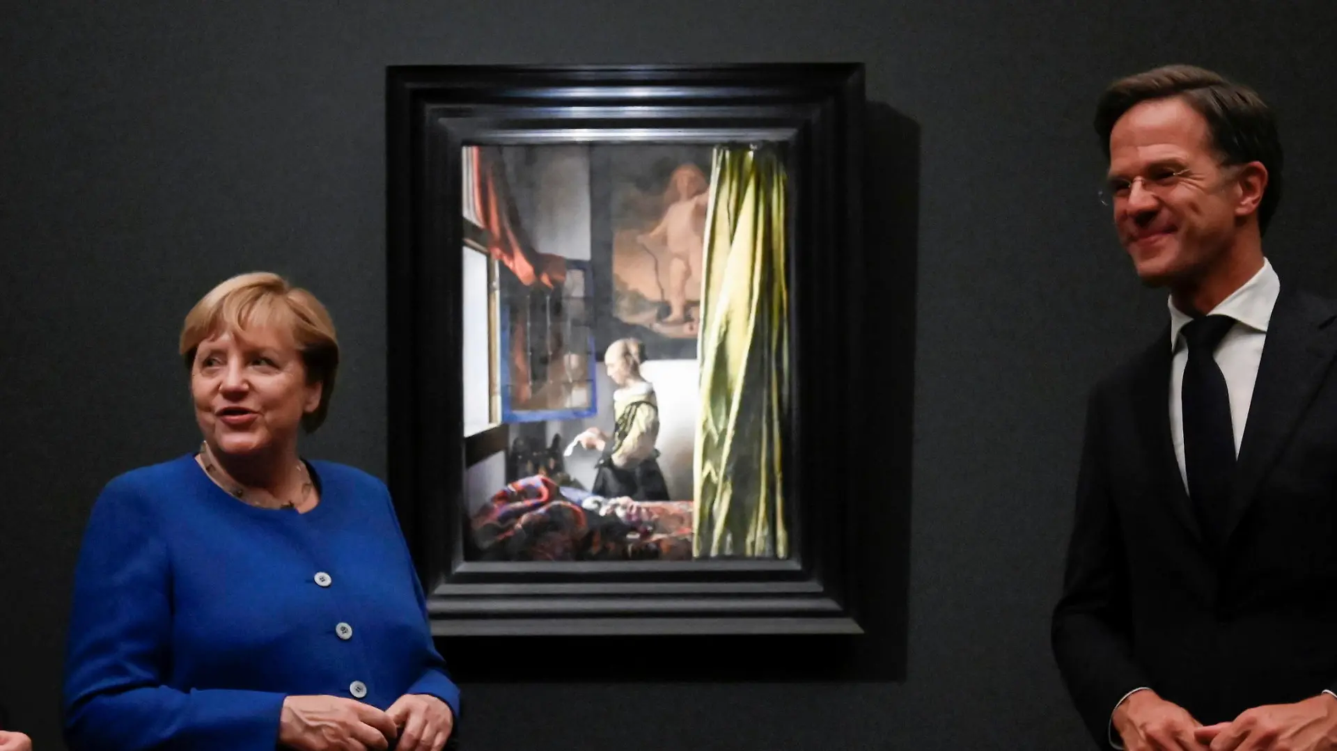 German Chancellor Angela Merkel, Netherlands' Prime Minister Mark Rutte and Saxony's Prime Minister Michael Kretschmer pose next to the painting "Girl Reading a Letter at an Open Window" as they open the largest exhibition on the Dutch painter Johannes Vermeer in Germany "Johannes Vermeer. On Reflection" at the Old Masters Picture Gallery of the Staatliche Kunstsammlungen Dresden (SKD), in Dresden, Germany, Thursday, Sept. 9, 2021. (Matthias Rietschel/Pool Photo via AP)