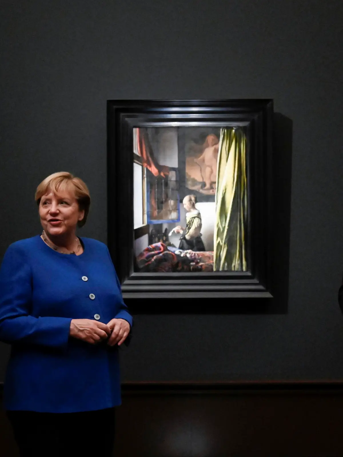 German Chancellor Angela Merkel, Netherlands' Prime Minister Mark Rutte and Saxony's Prime Minister Michael Kretschmer pose next to the painting "Girl Reading a Letter at an Open Window" as they open the largest exhibition on the Dutch painter Johannes Vermeer in Germany "Johannes Vermeer. On Reflection" at the Old Masters Picture Gallery of the Staatliche Kunstsammlungen Dresden (SKD), in Dresden, Germany, Thursday, Sept. 9, 2021. (Matthias Rietschel/Pool Photo via AP)