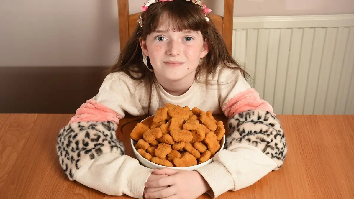WILLIAM LAILEY / MERCURY PRESS (PICTURED:  Jessica, 11, with a bowl of chicken nuggets)  -  A schoolgirl who lived off chicken nuggets for a DECADE has finally overcome her food phobia. Jessica, 11, spent her life so far eating just chicken nuggets after refusing to try new foods at 18 months old. Her mum, Julia, 49, a graphic designer, has no idea what triggered the anxiety and panic surrounding food - but after seeking professional help Jessica was diagnosed with avoidant restrictive food intake disorder (ARFID) just last month. Now after just a few weeks of work with her therapist who used relaxation MP4s to play before meals and rewards for overcoming her phobia, Jessica can finally enjoy a full roast dinner, as well as lots of fruit and vegetables. - SEE MERCURY COPY
