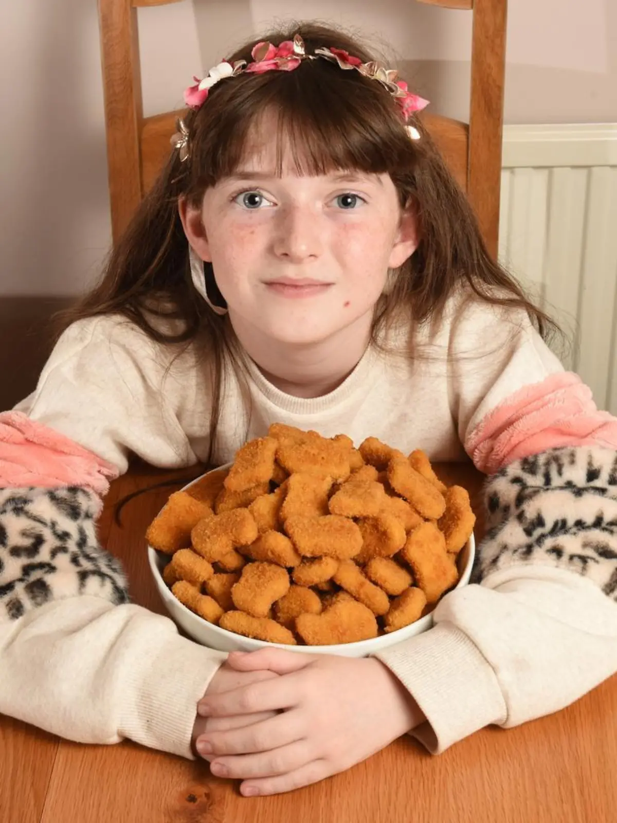WILLIAM LAILEY / MERCURY PRESS (PICTURED:  Jessica, 11, with a bowl of chicken nuggets)  -  A schoolgirl who lived off chicken nuggets for a DECADE has finally overcome her food phobia. Jessica, 11, spent her life so far eating just chicken nuggets after refusing to try new foods at 18 months old. Her mum, Julia, 49, a graphic designer, has no idea what triggered the anxiety and panic surrounding food - but after seeking professional help Jessica was diagnosed with avoidant restrictive food intake disorder (ARFID) just last month. Now after just a few weeks of work with her therapist who used relaxation MP4s to play before meals and rewards for overcoming her phobia, Jessica can finally enjoy a full roast dinner, as well as lots of fruit and vegetables. - SEE MERCURY COPY