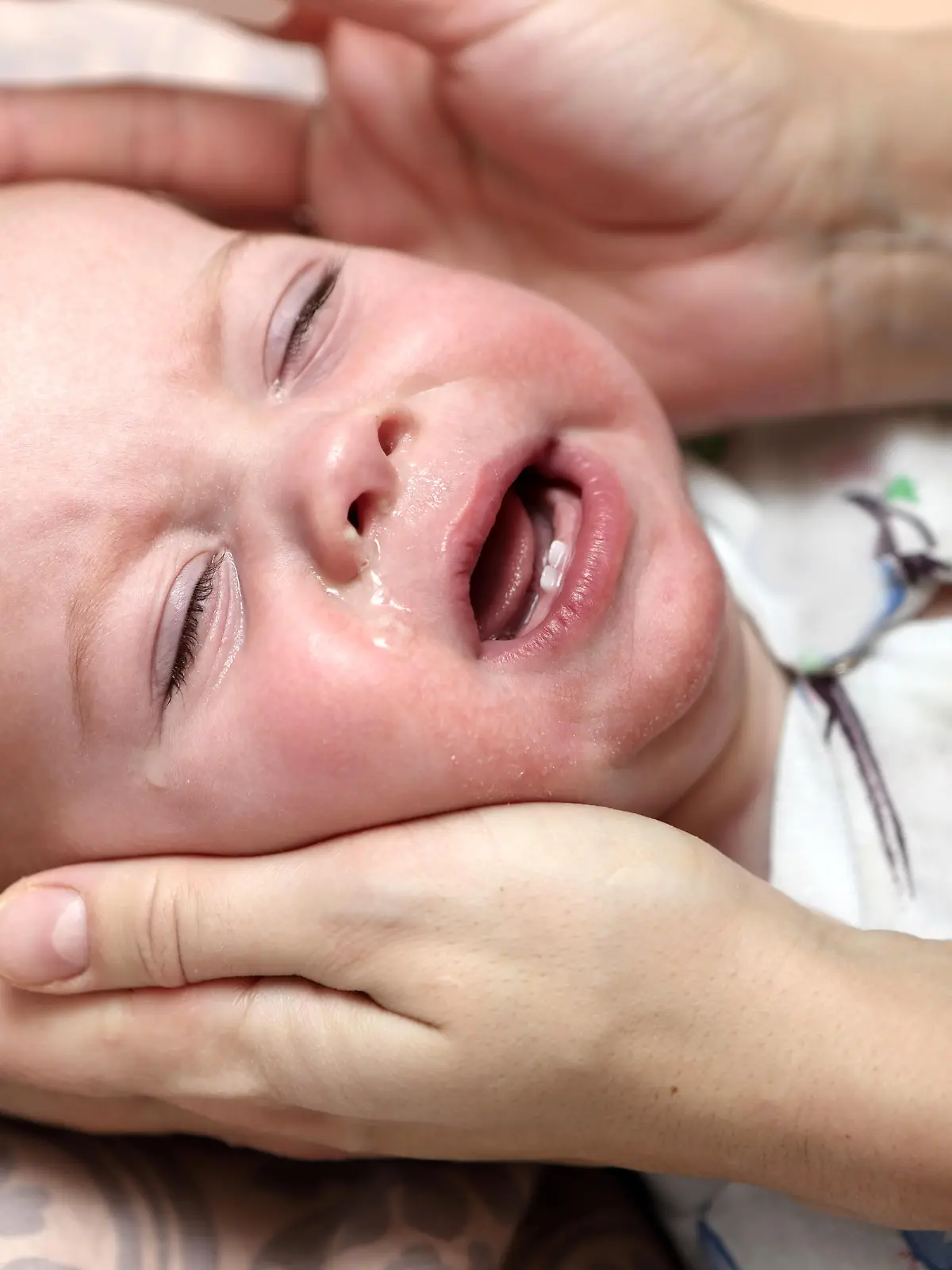 Crying child with a runny nose at home