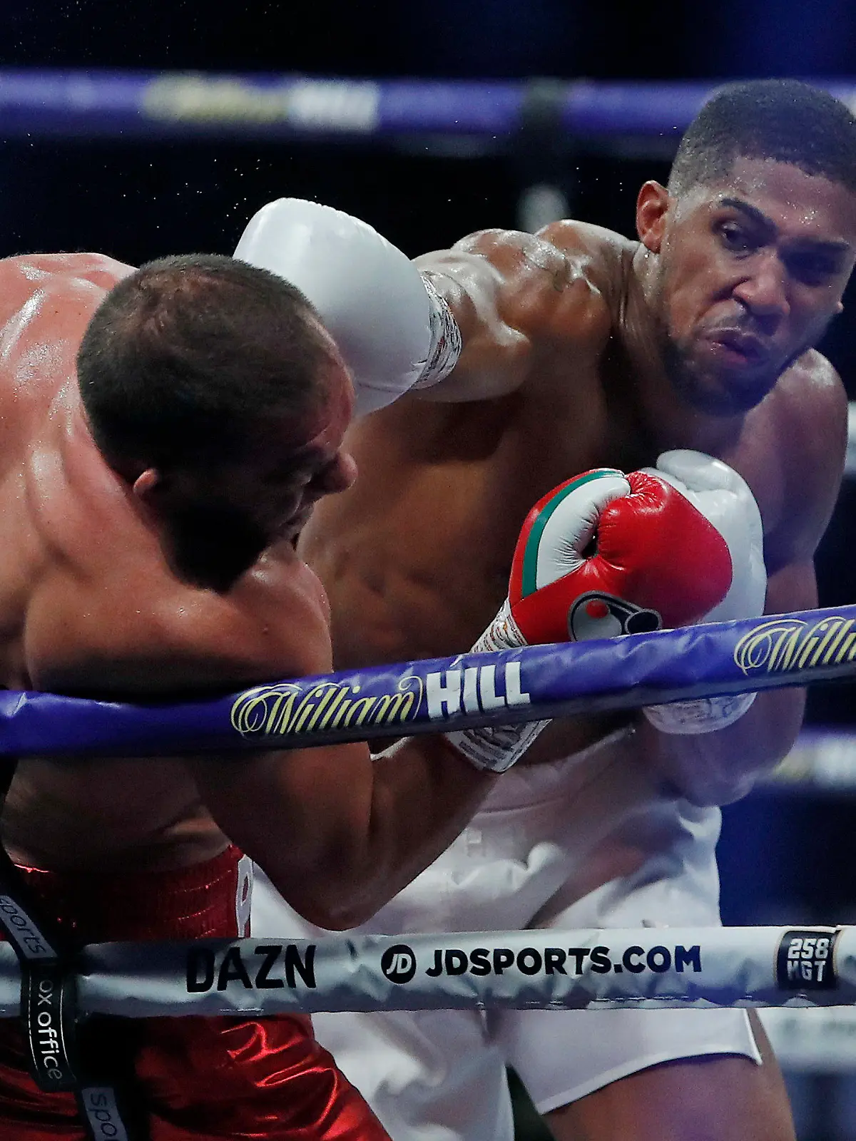World Heavyweight boxing champion Britain's Anthony Joshua lands a blow on challenger Bulgaria's Kubrat Pulev during their Heavyweight title fight at Wembley Arena in London Saturday, Dec. 12, 2020. (Andrew Couldridge/Pool via AP)