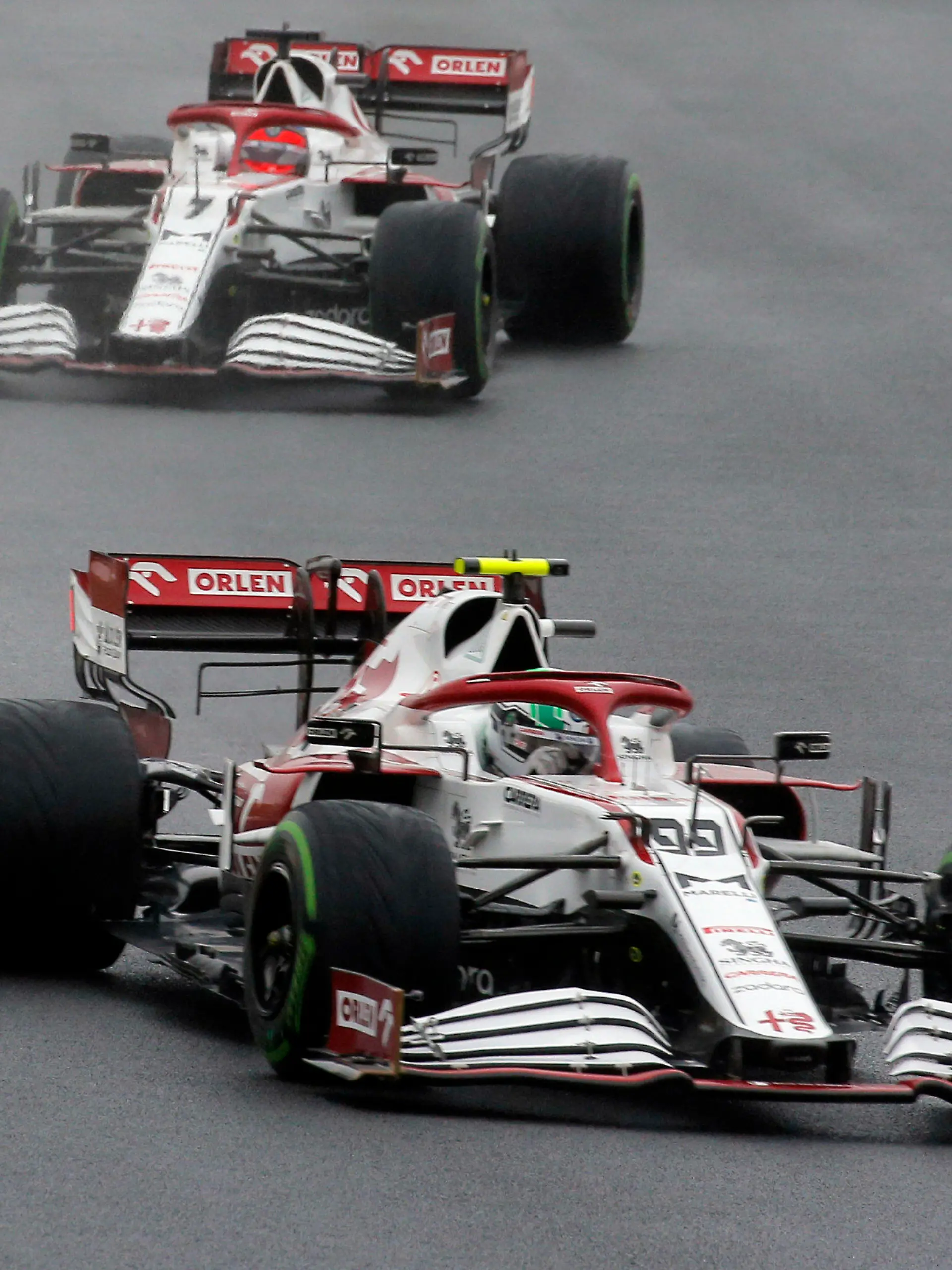 Alfa Romeo driver Antonio Giovinazzi of Italy steers his car followed by Alfa Romeo driver Kimi Raikkonen of Finland during the Turkish Formula One Grand Prix at the Intercity Istanbul Park circuit in Istanbul, Turkey, Sunday, Oct. 10, 2021. (AP Photo)