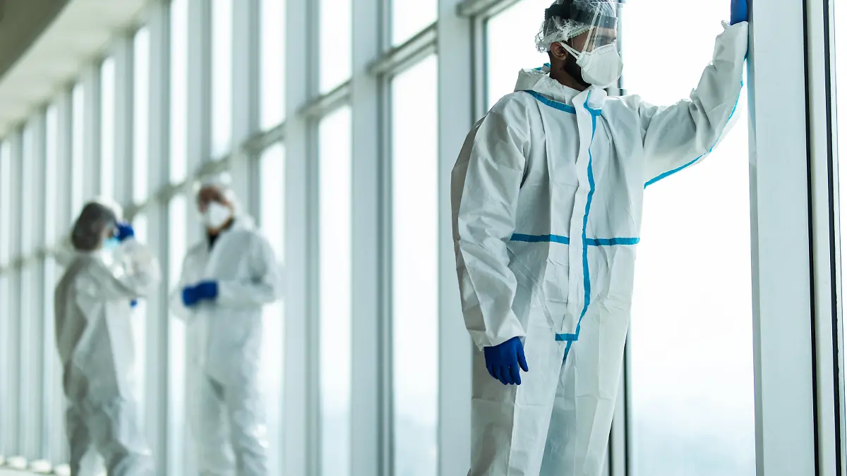 Coronavirus epidemic outbreak. Tired doctors with protective mask and respirator in the hospital