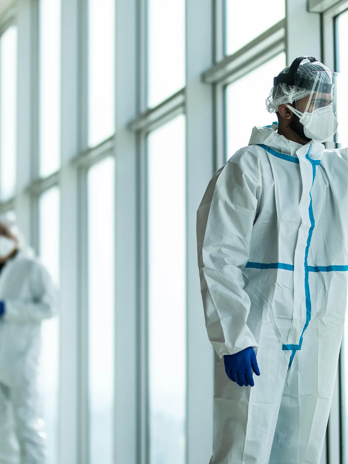 Coronavirus epidemic outbreak. Tired doctors with protective mask and respirator in the hospital