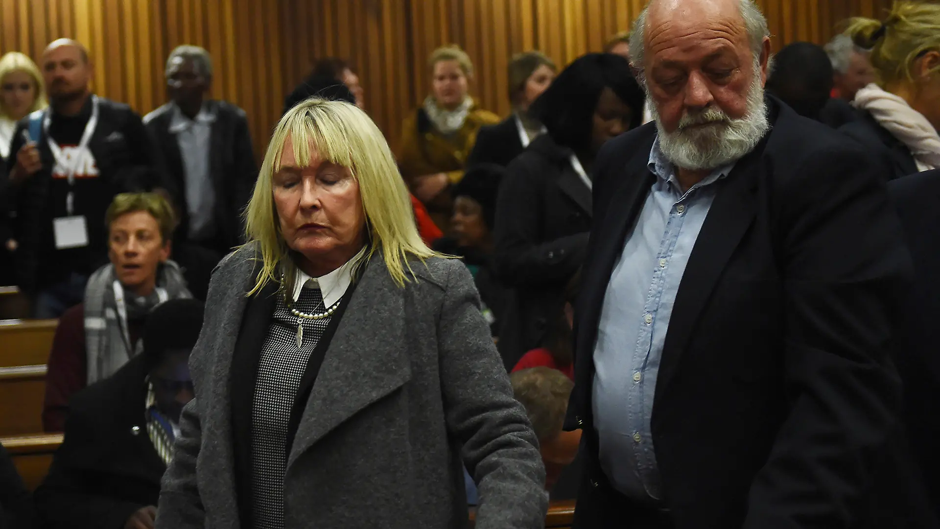 FILE — The parents of the late Reeve Steenkamp, June, left, and Barry Steenkamp, right, leave the High Court in Pretoria, South Africa, Wednesday, July 6, 2016. Eight years after he shot dead his girlfriend, Pistorius is up for parole, but first he must meet with her parents as part of the parole procedure. A parole hearing for Pistorius was scheduled for last month and then canceled, partly because a meeting between Pistorius and Steenkamp's parents, Barry and June, had not been arranged, lawyers for both parties told The Associated Press on Monday, Nov. 8, 2021. (Masi Losi/Pool Photo via AP, file)
