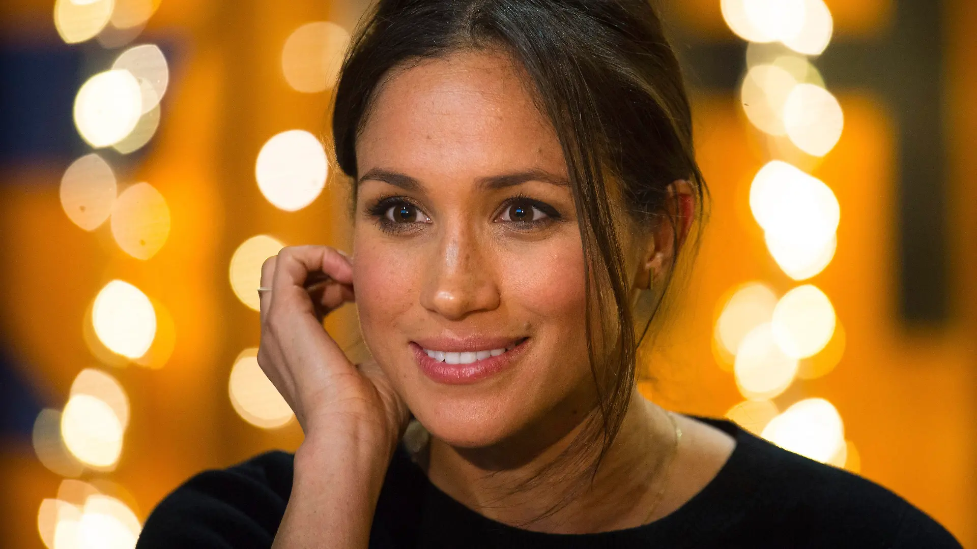 Meghan Markle smiles during a visit with Britain's Prince Harry to the Reprezent 107.3 FM radio station in Brixton, south London, Tuesday, Jan. 9, 2018. The royal couple visited Tuesday to see the station's work supporting young people through creative training in radio and broadcasting, and to learn more about their model of using music, radio and media for social impact. (AP Photo/ Dominic Lipinski, Pool)