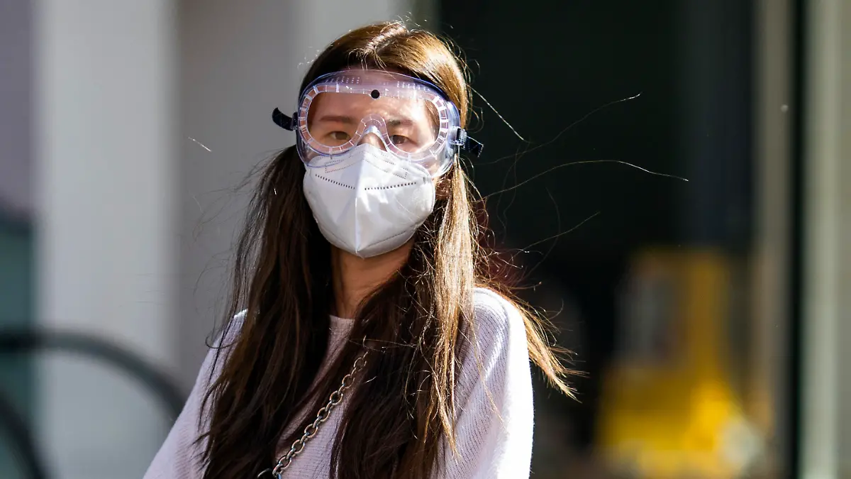LONDON, ENGLAND - APRIL 22: A woman wearing a face mask and goggles walks near Elephant and Castle underground station on April 22, 2020 in London, England. The British government has extended the lockdown restrictions first introduced on March 23 that are meant to slow the spread of COVID-19. (Photo by Dan Kitwood/Getty Images)